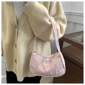 Pink shoulder bag detail showing FF logo texture and colorful tassel embellishments