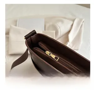 Macro shot showing smooth metal zipper and spacious interior of the brown tote bag