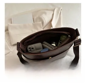 Top view of large brown tote bag interior showing spacious compartments and items