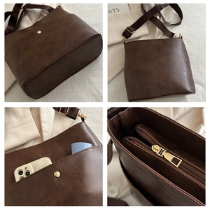 Detail view of coffee brown tote showing leather texture, zipper, and adjustable strap