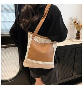 Woven beach tote bag with white mesh body and brown leather patch shown on shoulder