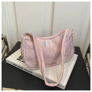 Macro view of pink shoulder bag featuring FF monogram texture and colorful embroidery