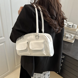 White faux leather tote bag with dual front flap pockets and silver metal hardware details