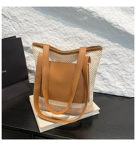 Detailed close-up of woven mesh texture and premium brown leather trim on a tote bag