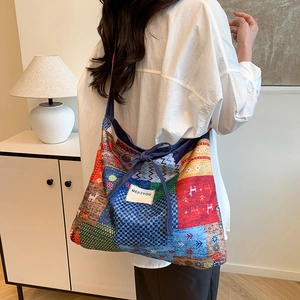 Chic patchwork print tote bag with geometric patterns and tassel ties in home setting
