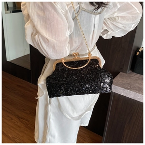 Detail of black sequin evening clutch bag with vintage gold metal frame and chain