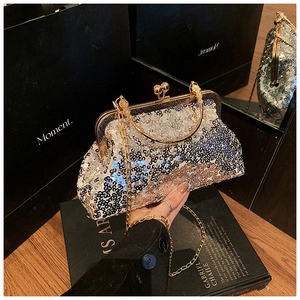 Close-up of elegant sequin evening clutch with gold chain strap and metal ring handle