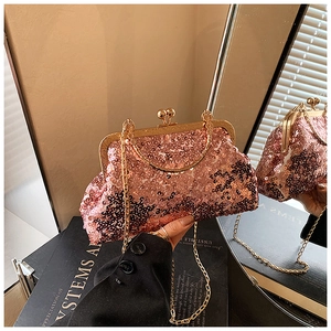 Detail of pink sequin shell bag with golden metal frame and detachable chain strap