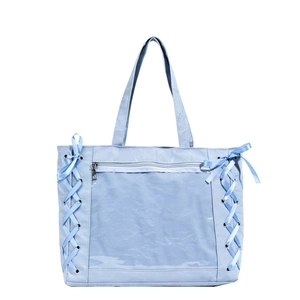 Light blue casual tote bag with transparent front pocket and side ribbon details