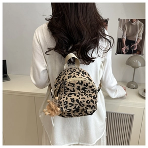 Mini leopard print corduroy backpack featuring top handle and cute plush lion charm