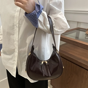 Chocolate brown leather crescent underarm bag with metal zippers and minimalist design