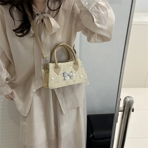 Mini trapezoid straw bag with floral embroidery and silver metal bow for women
