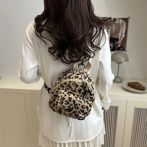 Chic leopard print corduroy mini backpack for women shown in a modern home setting