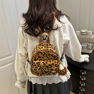 Minimalist leopard print corduroy backpack for women featuring a cute plush toy charm