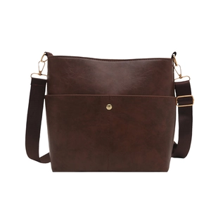 Vintage brown leather bucket bag with wide shoulder strap and gold hardware front pocket
