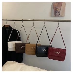 Five elegant bow shoulder bags in white, brown, black, and wine red with croc texture