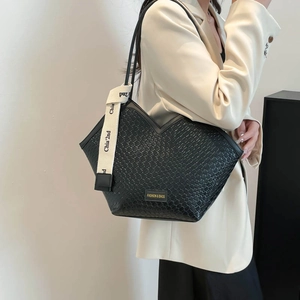 Chic black textured V-shape tote bag with fashion tag and cream woven strap detail