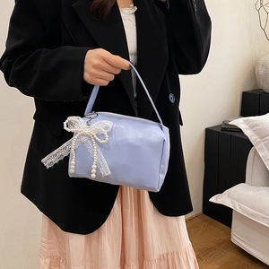 Fashionable light blue handbag with lace bow and pearls for spring 2025 casual style