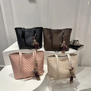 Large capacity monogram tote bags in four colors with cute bunny charms on display
