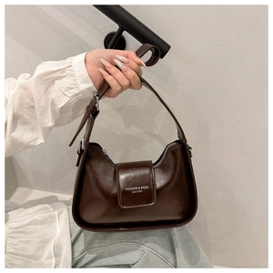 Detail of dark brown hobo bag with silver zipper and embossed fashion lettering