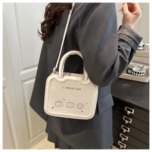 Detail of white wave-top crossbody bag featuring cute cartoon bears and premium gold lettering