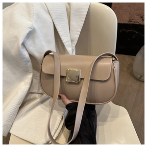 Detail of minimalist beige faux leather shoulder bag with elegant gold metal buckle