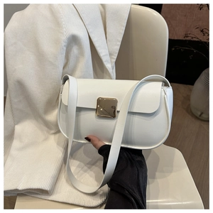 Close-up of a white minimalist shoulder bag featuring a square golden metal buckle detail
