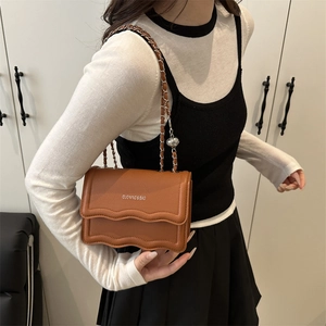Brown leather crossbody square bag with wave-edge flap and metal chain strap