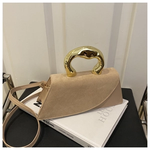 Close-up of beige crossbody bag featuring a unique gold sculptural handle and suede flap
