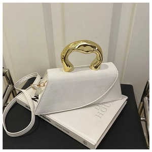 Detail of white square bag with matte suede texture and irregular golden metal handle