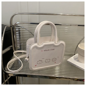 Detailed view of white mini square bag featuring wave edges and cute cartoon bear prints