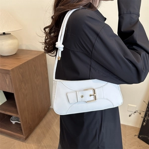 Minimalist white underarm bag with gold buckle and knot strap detail shown on model