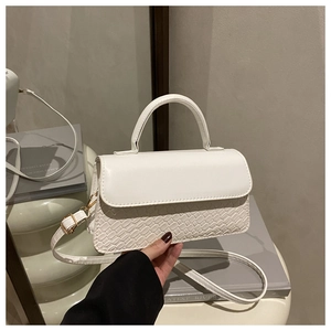 Detail of white textured crossbody bag with smooth leather flap and woven pattern design