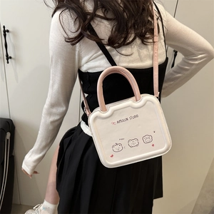 Chic white square handbag with pink handles and cute cartoon bear prints on a model