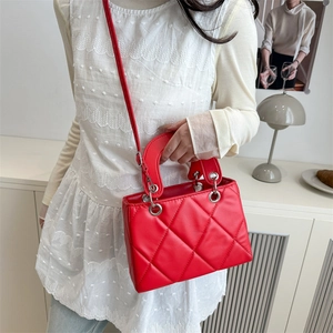 Minimalist red quilted square crossbody bag with silver hardware and shoulder strap