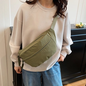 Minimalist olive green nylon crossbody bag with textured pleats and dual zipper pockets
