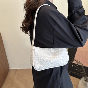Elegant white woven leather shoulder bag for women styled with black shirt outfit