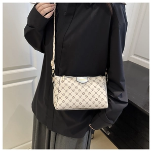 Fashionable white crossbody bag with small diamond pattern shown on a model