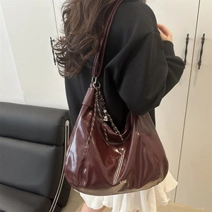 Minimalist deep wine red glossy leather shoulder bag in a large hobo tote style