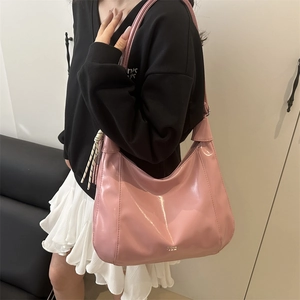 Minimalist pink glossy large tote bag worn as a shoulder bag in lifestyle setting
