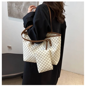 Détail du sac cabas vintage avec pochette assortie porté sur l'épaule du modèle