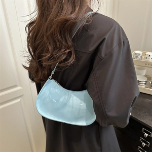 Chic light blue patent leather baguette bag shown as a stylish shoulder accessory