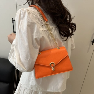 Orange crocodile embossed shoulder bag with gold horseshoe lock and chain strap