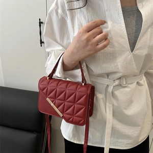 Red quilted leather crossbody bag with gold hardware and top handle for women