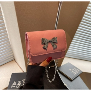 Detailed shot of pink PU leather mini bag with silver metal bow and chain strap