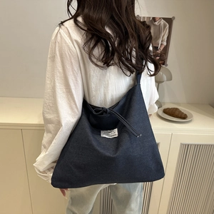 Minimalist large dark blue denim tote bag for women featuring a drawstring closure