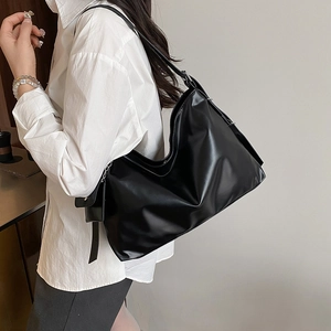 Minimalist black hobo tote bag for women featuring matte leather and silver hardware details