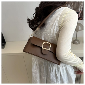 Borsa a spalla vintage in pelle PU marrone con fibbia dorata indossata dal modello