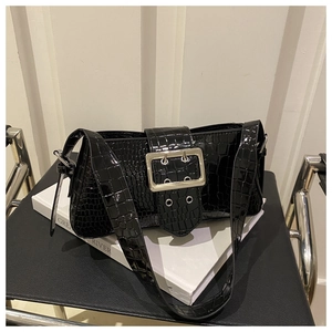Detail of a vintage black crocodile embossed shoulder bag with large silver square buckle