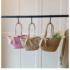 Detailed view of woven tote bags with lace bows in pink, beige, and brown colors